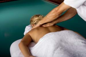 High angle view of a young woman getting a back massage from a massage therapist
